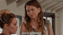 two women are standing next to each other and one of them is saying josh is wonderful