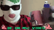 a man wearing a ski mask and sunglasses is holding a cup of coffee and says be on msc vibes .