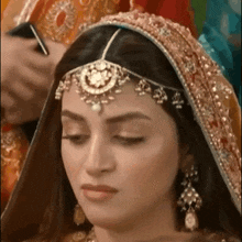 a close up of a woman 's face with a veil on