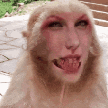 a close up of a monkey with a woman 's face on its face