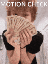 a person is holding a bunch of money in front of their face with the words motion check written above them