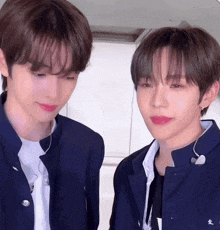 two young men are looking at each other and one has red lipstick on