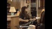 a person playing a guitar with the hashtag fuckshitup