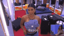 a woman standing in a dressing room with the word besos on the bottom