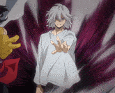 a man with gray hair and a white shirt is reaching out his hand