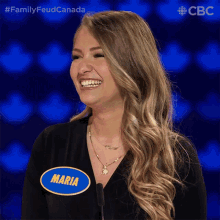 a woman with a name tag that says maria is smiling