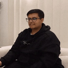 a man wearing glasses and a black hoodie that says life for you on it