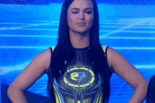 a woman in a superhero costume is standing with her hands on her hips and smiling .