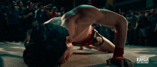 a man is crawling on the floor with the word kahar on the bottom