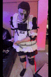 a man in a maid costume holds a knife