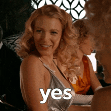 a woman in a silver dress with the word yes written on her chest