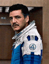 a man with a mustache is wearing a blue and white space suit with the number 4 on the shoulder