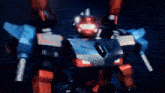 a robot with red and blue arms and a red light on its head
