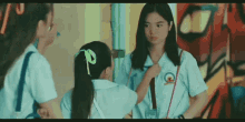a girl in a school uniform has the letter c on her chest