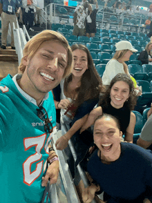 a man wearing a miami dolphins jersey poses for a picture