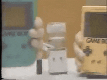 a yellow game boy sits next to a green game boy