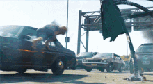 a man is jumping over a car with a license plate that says nj