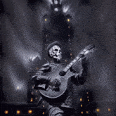 a statue of a skeleton is playing a guitar