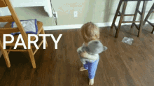 a little girl is holding a stuffed animal and the word party is behind her