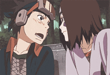 a boy and a girl are looking at each other and the girl is wearing headphones