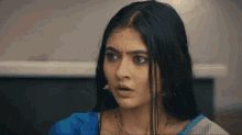 a close up of a woman making a surprised face