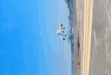 a large white airplane is sitting on a runway with a blue sky in the background