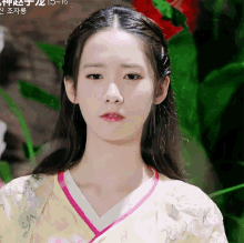a woman in a yellow and pink kimono with flowers on it