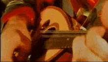 a person is playing a guitar in a blurry photo