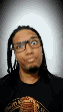 a man wearing glasses and a black shirt that says " always "