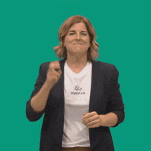 a woman wearing a eversa t-shirt is making a funny face