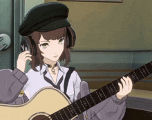 a girl wearing headphones and a hat is playing a guitar