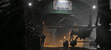 a sign for bryan 's boat works and marina hangs from a building