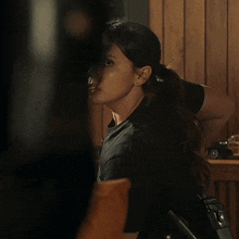 a woman in a black t-shirt with a sticker on it that says ' i love you ' on it