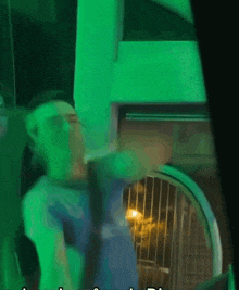 a blurry picture of a person in a green room with the letters ld on the bottom right