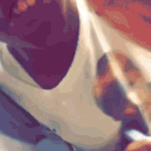 a man in a white tank top is taking a selfie with his cell phone .