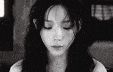 a black and white photo of a woman 's face with the letters eee visible