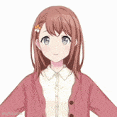 a girl with a flower in her hair is wearing a pink cardigan and a white shirt .