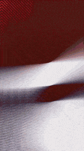 a red and white striped background with a shadow on the ground