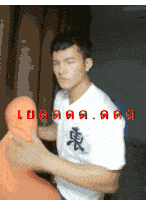 a man wearing a white shirt with asian writing on it