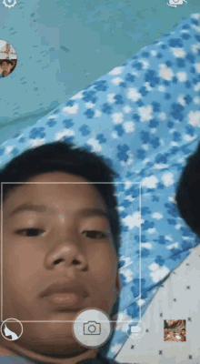 a young boy is taking a picture with a camera