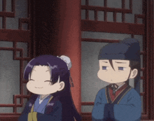 a man and a woman are standing next to each other and the woman is smiling