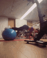 a woman is doing push ups with a blue ball