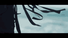 a close up of a person 's hair with ribbons blowing in the wind .