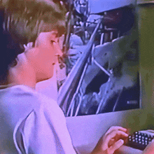 a person is typing on a keyboard in front of a monitor