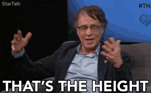 a man in a suit says that 's the height with his arms outstretched