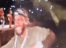 a man wearing a nike hat stands in front of a microphone