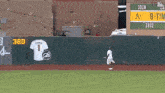 a baseball field with a fence and a scoreboard that says ' 1910 1972 ' on it