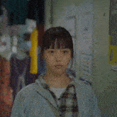 a person with their mouth open looking up at a wall