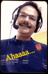 a man wearing headphones and a blue shirt that says spirit