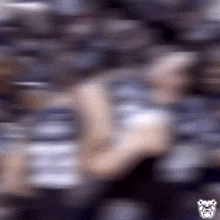 a blurry picture of a person with a bulldog logo on the bottom